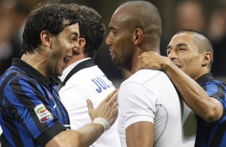 Inter Milan Brazilian defender Maicon, right, celebrates with his teammate Argentine forward Diego Milito, of Argentina, after he scored during a Serie A soccer match between Inter Milan and AC Milan, at the San Siro stadium in Milan, Italy, Sunday, May 6, 2012. (AP Photo/Luca Bruno)