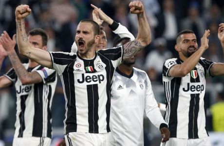 FILE - In this Tuesday, May 9, 2017 file photo, Juventus' Leonardo Bonucci, front, celebrates after the Champions League semi final second leg soccer match between Juventus and Monaco in Turin, Italy.  Juventus defeated Monaco by 2-1.  Juventus keeps on breaking records. And it set another one on Sunday when it clinched an unprecedented sixth successive Serie A title, with one game to spare, following a victory over Crotone. It is the first time since Serie A was founded in 1929 that a club has won six straight titles. (AP Photo/Antonio Calanni, File)