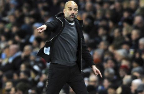Manchester City manager Josep Guardiola gives directions to his players during the English Premier League soccer match between Manchester City and Leicester City at the Etihad Stadium in Manchester, England, Saturday, Feb. 10, 2018. (AP Photo/Rui Vieira)