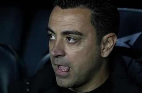 Barcelona's head coach Xavi Hernandez concentrates prior the start of the Spanish Copa del Rey semi final, second leg soccer match between Barcelona and Real Madrid at the Camp Nou stadium in Barcelona, Spain, Wednesday, April 5, 2023. (AP Photo/Joan Mateu Parra)