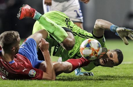Czech Republic's Tomas Soucek, left, and Kosovo's keeper Arijanet Muric challenge for the ball during the Euro 2020 group A qualifying soccer match between Czech Republic and Kosovo in Pilsen, Czech Republic, Thursday, Nov. 14, 2019. (AP Photo/Petr David Josek)