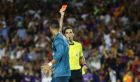In this photo taken on Sunday, Aug. 13, 2017, referee Ricardo de Burgos, right, shows a red card to Real Madrid's Cristiano Ronaldo during the Spanish Supercup, first leg, soccer match between FC Barcelona and Real Madrid at the Camp Nou stadium in Barcelona, Spain. Cristiano Ronaldo was banned for five games on Monday after shoving a referee following his red card for diving in Real Madrid's 3-1 win over Barcelona in the season-opening Spanish Super Cup. (AP Photo/Manu Fernandez)