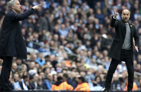 Manchester City coach Pep Guardiola and Manchester United manager Jose Mourinho, left, gesture from the sideline during the English Premier League soccer match between Manchester City and Manchester United at the Etihad Stadium in Manchester, England, Saturday April 7, 2018. (AP Photo/Matt Dunham)