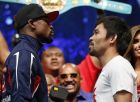 Floyd Mayweather Jr., left, and Manny Pacquiao pose during their weigh-in on Friday, May 1, 2015 in Las Vegas. The world weltherweight title fight between Mayweather Jr. and Pacquiao is scheduled for May 2. (AP Photo/John Locher)