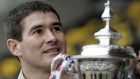 Burton Albion manager Nigel Clough stands near the FA Cup at the Pirelli Stadium in Burton-on-Trent, England, Friday Jan. 6, 2006 as the non-league soccer club prepares to take on English soccer giants Manchester United on Sunday. The FA Cup is the one major domestic trophy to elude Nigel's father, the late  Brian Clough, during his illustrious career as both player and manager. (AP Photo/Dave Thompson) 