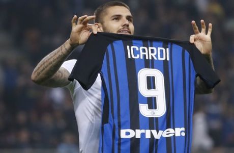 Inter Milan's Mauro Icardi shows his jersey to fans as he celebrates after scoring his side's 3rd goal during the Serie A soccer match between Inter Milan and AC Milan, at the Milan San Siro Stadium, Italy, Sunday, Oct. 15, 2017. (AP Photo/Antonio Calanni)