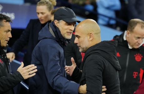 Manchester City's head coach Pep Guardiola, right, greets, Bayern's head coach Thomas Tuchel prior to the start of the Champions League quarterfinal, first leg, soccer match between Manchester City and Bayern Munich at the Etihad stadium in Manchester, England, Tuesday, April 11, 2023. (AP Photo/Jon Super)