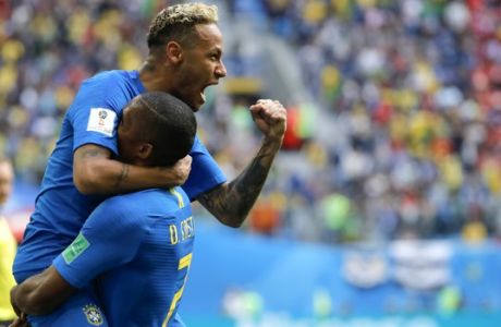 Brazil's Neymar, top, celebrates with teammate Douglas Costa after scoring his side's second goal during the group E match between Brazil and Costa Rica at the 2018 soccer World Cup in the St. Petersburg Stadium in St. Petersburg, Russia, Friday, June 22, 2018. (AP Photo/Dmitri Lovetsky)