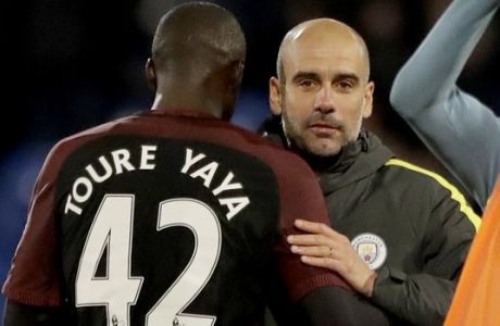 Manchester City's Yaya Toure, who scored both their goals, celebrates with his head coach Pep Guardiola after the English Premier League soccer match between Crystal Palace and Manchester City at Selhurst Park stadium in London, Saturday, Nov. 19, 2016. (AP Photo/Matt Dunham)