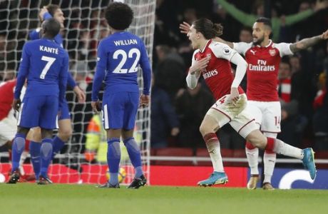 Arsenal's Hector Bellerin, second right, celebrates scoring his side's second goal during the English Premier League soccer match between Arsenal and Chelsea at Emirates stadium in London, Wednesday, Jan. 3, 2018. (AP Photo/Frank Augstein)