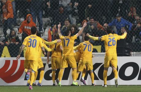 APOEL's players celebrate after teammate Pieros Sotiriou scores a goal against Athletic Bilbao during the Europa League round of 32 second leg soccer match between APOEL and Athletic Bilbao at the GSP stadium, in Nicosia, Cyprus, on Thursday, Feb. 23, 2017. (AP Photo/Petros Karadjias)