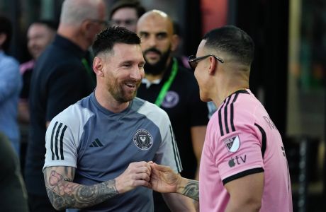 Inter Miami forward Lionel Messi, left, greets rapper Daddy Yankee, right, as he arrives to the field ahead of an MLS soccer match against the Colorado Rapids, Saturday, April 6, 2024, in Fort Lauderdale, Fla. (AP Photo/Rebecca Blackwell)