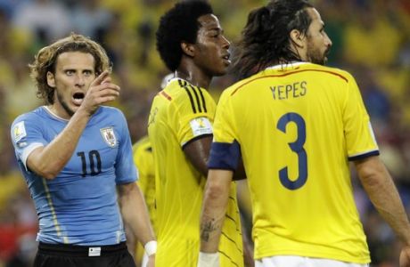 Uruguay's Diego Forlan, left, shouts at Colombia's Mario Yepes during the World Cup round of 16 soccer match between Colombia and Uruguay at the Maracana Stadium in Rio de Janeiro, Brazil, Saturday, June 28, 2014. (AP Photo/Matt Dunham)