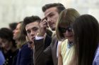 David Beckham, center, husband of designer Victoria Beckham, and their son Brooklyn Beckham, sit in the front row as they wait for her Spring 2016 collection to be modeled during Fashion Week, in New York, Sunday, Sept. 13, 2015. Seated at right is Anna Wintour, editor-in-chief of American Vogue. (AP Photo/Richard Drew)