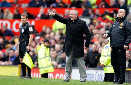 Manchester United's manager Sir Alex Ferguson, centre gesticulates during his team's 4-4 draw against Everton in their English Premier League soccer match at Old Trafford Stadium, Manchester, England, Sunday, April 22, 2012. (AP Photo/Jon Super)