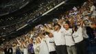 Real Madrid supporters watch on big screens placed at the team's Santiago Bernabeu stadium in Madrid, Spain to celebrate their team who won the Champions League final match against Liverpool played in Kiev, Ukraine, Saturday, May 26, 2018. Real Madrid won 3-1. (AP Photo/Francisco Seco)