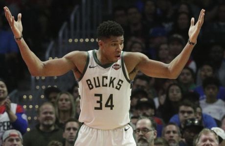 Milwaukee Bucks' Giannis Antetokounmpo, left, of Greece, looks at Los Angeles Clippers' Danilo Gallinari, of Italy, after getting a foul call during the second half of an NBA basketball game Saturday, Nov. 10, 2018, in Los Angeles. The Clippers won 128-126 in overtime. (AP Photo/Jae C. Hong)
