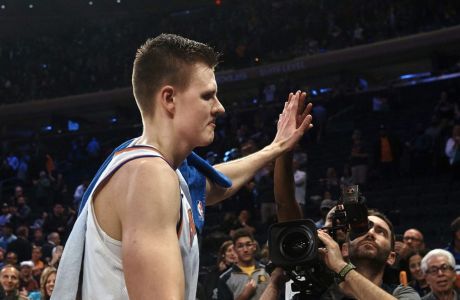 New York Knicks' Kristaps Porzingis celebrates with fans after an NBA basketball game against Indiana Pacers at Madison Square Garden in New York, Sunday, Nov. 5, 2017. Porzingis scored a career-high 40 points, carrying the Knicks back from a 19-point deficit to a 108-101 victory over the Pacers on Sunday night.
 (AP Photo/Andres Kudacki)