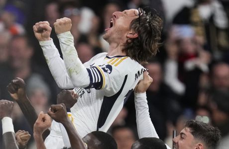 Real Madrid's Luka Modric celebrates with his teammates after scoring his team's first goal during the Spanish La Liga soccer match between Real Madrid and Sevilla at the Santiago Bernabeu stadium in Madrid, Spain, Sunday, Feb. 25, 2024. (AP Photo/Manu Fernandez)