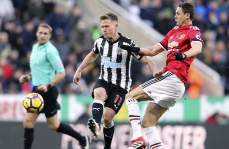 Newcastle United's Matt Ritchie, left, and Manchester United's Nemanja Matic battle for the ball during their English Premier League soccer match at St James' Park, Newcastle, England, Sunday, Feb. 11, 2018. (Owen Humphreys/PA via AP)