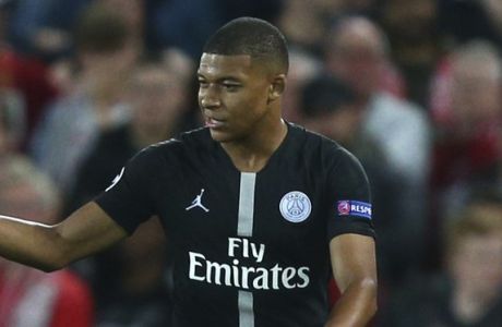 PSG's Kylian Mbappe, right, celebrates scoring his sides second goal during the Champions League Group C soccer match between Liverpool and Paris-Saint-Germain at Anfield stadium in Liverpool, England, Tuesday, Sept. 18, 2018. (AP Photo/Dave Thompson)