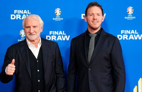 FILE - Rudi Voeller, left, director of the Germany national soccer team and Germany's head coach Julian Nagelsmann, right, arrive for the draw for the UEFA Euro 2024 soccer tournament in Hamburg, Germany, Saturday, Dec. 2, 2023. Rudi Völler is set to stay on as sporting director of the German mens national soccer team through to the 2026 World Cup. (AP Photo/Martin Meissner, File)