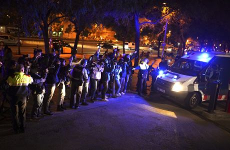 Reporters take pictures of a police van, allegedly carrying soccer player Dani Alves, outside the Barcelona courthouse, Spain, Friday, Jan. 20, 2023. Brazilian soccer player Dani Alves has been arrested after being accused of sexually assaulting a woman in Barcelona. Police say the alleged act took place on Dec. 31 at a night club in Barcelona. (AP Photo/Joan Mateu Parra)