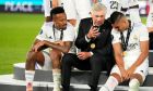 Real Madrid's head coach Carlo Ancelotti, center, speaks with Eder Militao, left, and Casemiro after winning the UEFA Super Cup final soccer match between Real Madrid and Eintracht Frankfurt at Helsinki's Olympic Stadium, Finland, Wednesday, Aug. 10, 2022. (AP Photo/Sergei Grits)