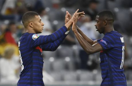 France's Kylian Mbappe, left, and France's Ousmane Dembele celebrate after the Euro 2020 soccer championship group F match between Germany and France at the Allianz Arena stadium in Munich, Tuesday, June 15, 2021. (Franck Fife/Pool via AP)