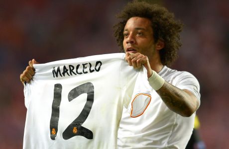 Real's Marcelo holds up his shirt, at the end of theChampions League final soccer match between Atletico Madrid and Real Madrid in Lisbon, Portugal, Saturday, May 24, 2014. Real Madrid won 4-1. (AP Photo/Manu Fernandez)