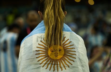 A fan wrapped in an Argentina flag sits at the stands prior the World Cup quarterfinal soccer match between the Netherlands and Argentina, at the Lusail Stadium in Lusail, Qatar, Friday, Dec. 9, 2022. (AP Photo/Francisco Seco)