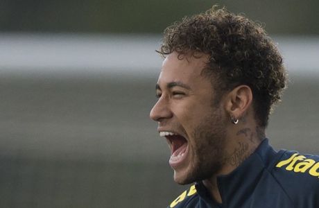 Brazil's Neymar laughs aloud while clowning around with teammates during a national soccer team practice session ahead the World Cup in Russia, at the Granja Comary training center In Teresopolis, Brazil, Friday, May 25, 2018. Neymar, the worlds highest paid soccer player, is nearly recovered from a foot operation and has joined 16 of his teammates in Teresopolis, looking ahead to competing in Russia at the World Cup in July. (AP Photo/Leo Correa)