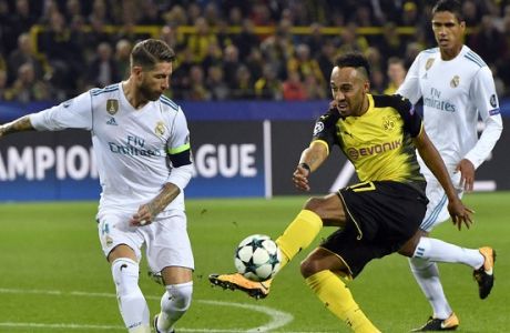 Real Madrid's Sergio Ramos, left, and Dortmund's Pierre-Emerick Aubameyang, right, challenge for the ball during the Champions League group H soccer match between Borussia Dortmund and Real Madrid CF in Dortmund, Germany, Tuesday, Sept. 26, 2017. (AP Photo/Martin Meissner)