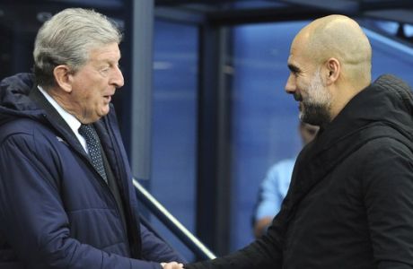 Manchester City manager Josep Guardiola, right, and Crystal Palace manager Roy Hodgson shake hands prior to the English Premier League soccer match between Manchester City and Crystal Palace at Etihad stadium in Manchester, England, Saturday, Dec. 22, 2018. (AP Photo/Rui Vieira)