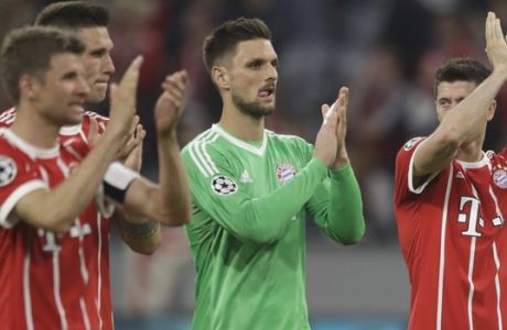Bayern's Thomas Mueller, Niklas Suele, Sven Ulreich and Robert Lewandowski, from left, acknowledge the fans after losing 1-2 during the semifinal first leg soccer match between FC Bayern Munich and Real Madrid at the Allianz Arena stadium in Munich, Germany, Wednesday, April 25, 2018. (AP Photo/Matthias Schrader)