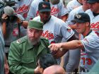 Cuban President Fidel Castro talks to Baseball players Mike Murphy (ri) and Alberto Belle (c) prior to the opening of a friendly match between Cuba and the Baltimore Orioles, in Havana on March 28th.