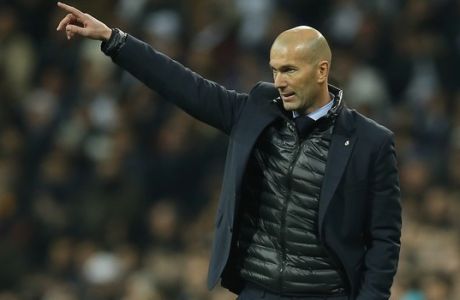 Real Madrid coach Zinedine Zidane gives instructions to his players during the Champions League soccer match, round of 16, 1st leg between Real Madrid and Paris Saint Germain at the Santiago Bernabeu stadium in Madrid, Spain, Wednesday, Feb. 14, 2018. (AP Photo/Paul White)
