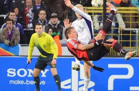 AC Milan player Philippe Mexes kicks the ball to score against RSC Anderlecht during the Group C Champions League soccer match in Brussels on Wednesday, Nov. 21, 2012. (AP Photo/Geert Vanden Wijngaert)