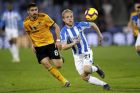 Huddersfield Town's Alex Pritchard, right, and Wolverhampton Wanderers' Ruben Neves battle for the ball during the Premier League match at the John Smith's Stadium, Huddersfield, Tuesday February 26, 2019. (Martin Rickett/PA via AP)
