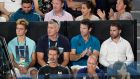 Serena Williams' coach, Patrick Mouratoglou, bottom left, sits in the player box of Greece's Stefanos Tsitsipas during his fourth round match against Switzerland's Roger Federer at the Australian Open tennis championships in Melbourne, Australia, Sunday, Jan. 20, 2019. (AP Photo/Aaron Favila)