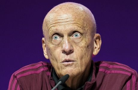 Chairman of the FIFA referees committee Pierluigi Collina , center, talks to the media at a press conference of the FIFA referees at the World Cup media center in Doha, Qatar, Friday, Nov. 18, 2022.(AP Photo/Martin Meissner)