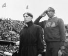 The ceremony honoring the three winners in the 100 meter Olympic final in Berlin on August 3, 1936, which was won by Jessie Owens, U.S.A, middle, second was Tinus Osendarp, Holland, front, and third Ralph Metcalf, U.S.A. (extreme right). (AP Photo)