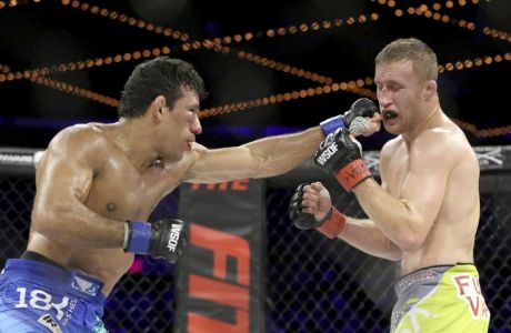 Luiz Firmino. left, in action against Justin Gaethje during their WSOF lightweight title fight at the Theater at Madison Square Garden in New York on Saturday, December 31, 2016. Gaethje won by doctor stoppage after the 3rd round when Firmino could not see out of his right eye. (AP Photo/Gregory Payan)
