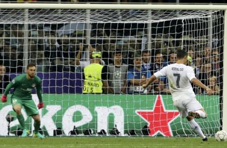 Real Madrid's Cristiano Ronaldo scores the decisive penalty kick during the Champions League final soccer match between Real Madrid and Atletico Madrid at the San Siro stadium in Milan, Italy, Saturday, May 28, 2016. Real Madrid won 5-4 on penalties after the match ended 1-1 after extra time.  (AP Photo/Luca Bruno)