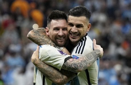 Argentina's Lionel Messi and Leandro Paredes, right, celebrate at the end of the World Cup quarterfinal soccer match between the Netherlands and Argentina, at the Lusail Stadium in Lusail, Qatar, Saturday, Dec. 10, 2022. Argentina defeated the Netherlands 4-3 in a penalty shootout after the match ended tied 2-2. (AP Photo/Ricardo Mazalan)