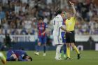 Barcelona's Lionel Messi lies on the ground as Real Madrid's Sergio Ramos is shown the red card by the referee after fouling Messi during a Spanish La Liga soccer match between Real Madrid and Barcelona, dubbed 'el clasico', at the Santiago Bernabeu stadium in Madrid, Spain, Sunday, April 23, 2017. (AP Photo/Daniel Ochoa de Olza)