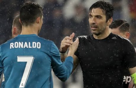 FILE - In this Tuesday, April 3, 2018 filer, Juventus goalkeeper Gianluigi Buffon, right, shakes hands with Real Madrid's Cristiano Ronaldo after the Champions League, round of 8, first-leg soccer match between Juventus and Real Madrid at the Allianz stadium in Turin, Italy. Juventus captain Gianluigi Buffon has announced he is leaving the Italian club but the goalkeeper could continue playing elsewhere. Buffon, who is widely regarded as one of the best goalkeepers of all time, was expected to announce his retirement at a press conference at Allianz Stadium on Thursday, May 17, 2018. (AP Photo/Luca Bruno, File)
