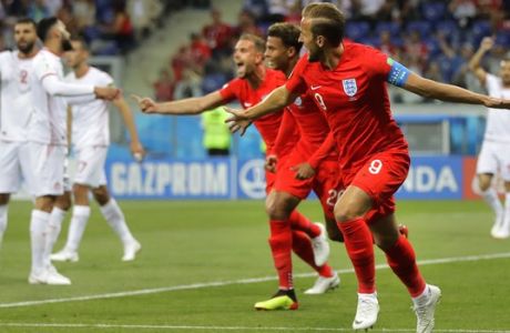 England's Harry Kane, foreground right, celebrates after scoring his side's opening goal against Tunisia during the group G match between Tunisia and England at the 2018 soccer World Cup in the Volgograd Arena in Volgograd, Russia, Monday, June 18, 2018. (AP Photo/Sergei Grits)