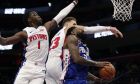 Philadelphia 76ers center Amir Johnson (5) is defended by Detroit Pistons guard Reggie Jackson (1) and forward Blake Griffin (23) during the second half of an NBA basketball game, Tuesday, Oct. 23, 2018, in Detroit. (AP Photo/Carlos Osorio)