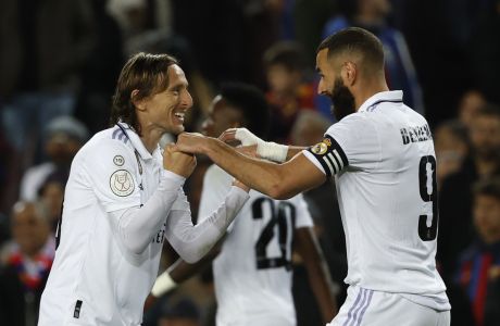 Real Madrid's Karim Benzema, right, celebrates with his teammate Luka Modric after scoring his side's third goal during the Spanish Copa del Rey semifinal, second leg soccer match between Barcelona and Real Madrid at the Camp Nou stadium in Barcelona, Spain, Wednesday, April 5, 2023. (AP Photo/Joan Monfort)